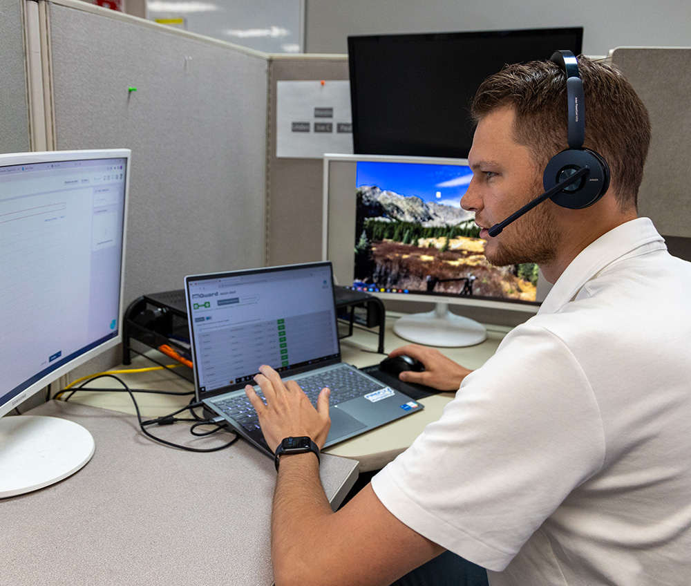 FireFly helpdesk technician on phone at desk